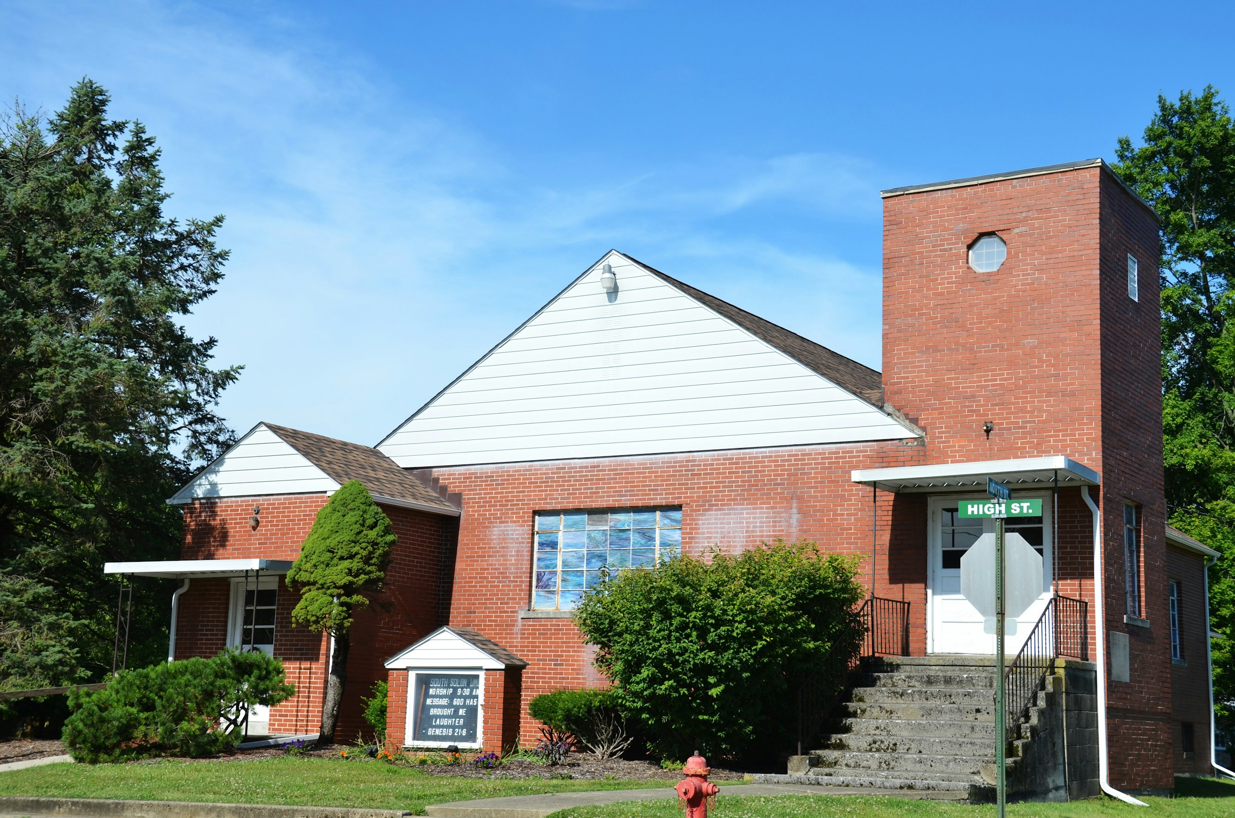 Red-brick church exterior with a bell tower