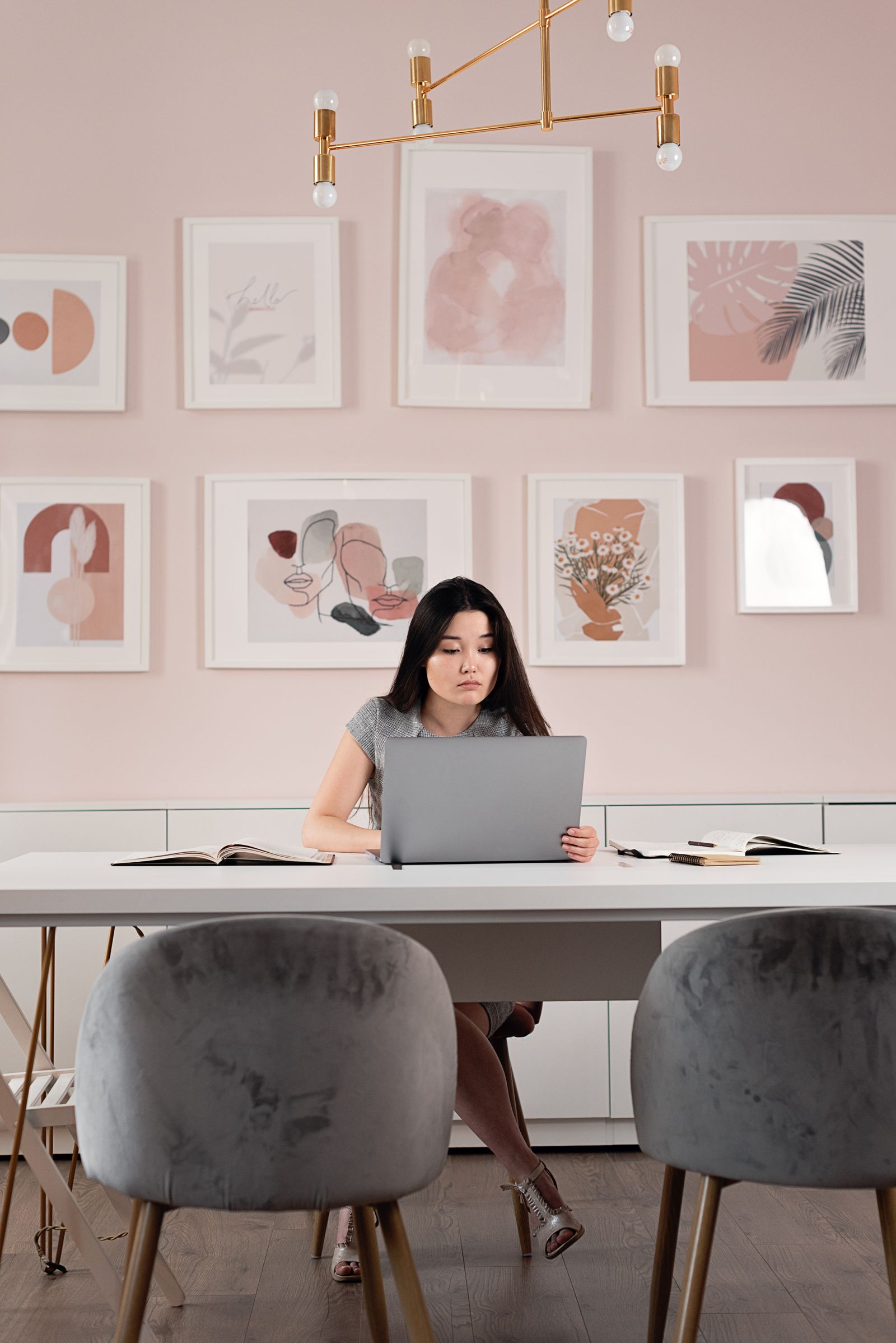 Woman working on a laptop at a table