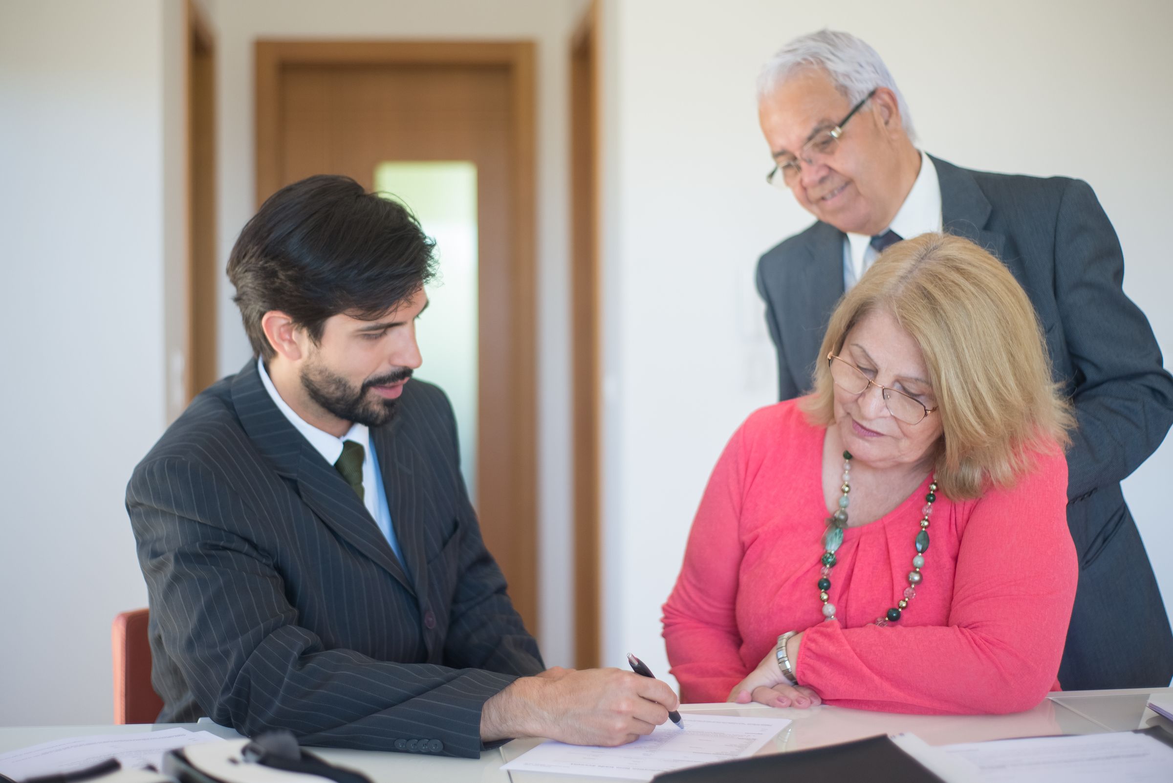 Couple reviewing paperwork with a professional advisor