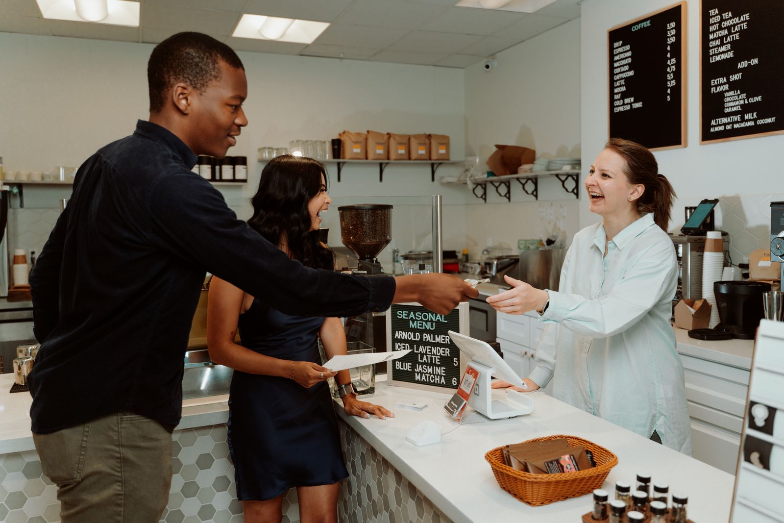 Customer paying a cashier in a coffee shop